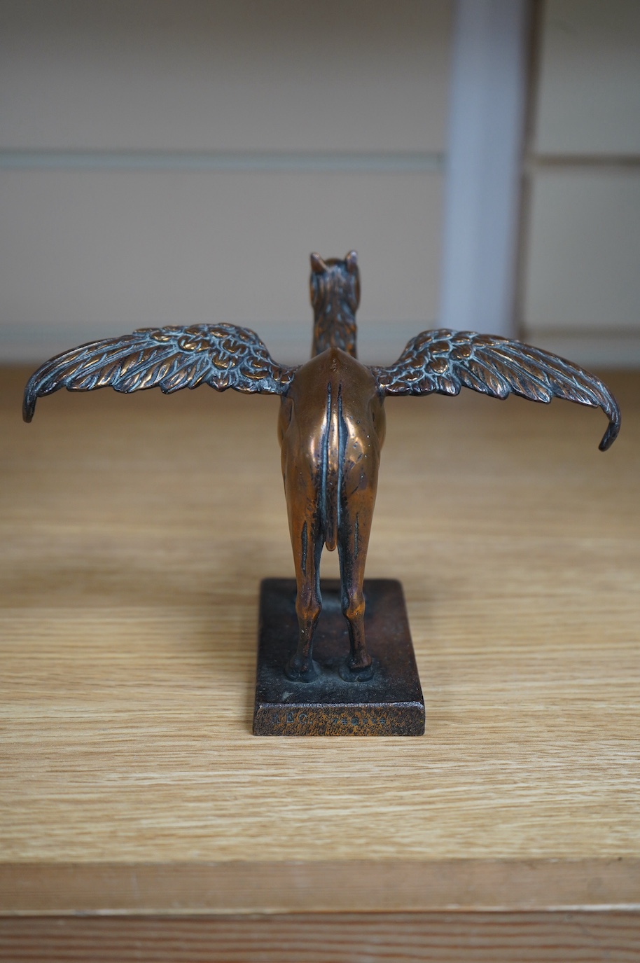 A bronze Royal Air Force 45th Squadron winged camel desk ornament, stamped Reg.746774 to the base